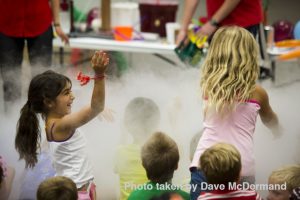 Children waving their arms into a nitrogen cloud