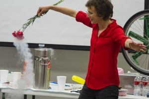 Dr. Tatiana pulling frozen rose out of liquid nitrogen