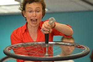 Dr. Tatiana displaying a wheel spinning sideways in place with a center of motion