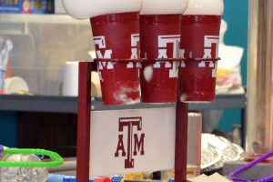 Texas A&M cups holding balloons with different chemicals