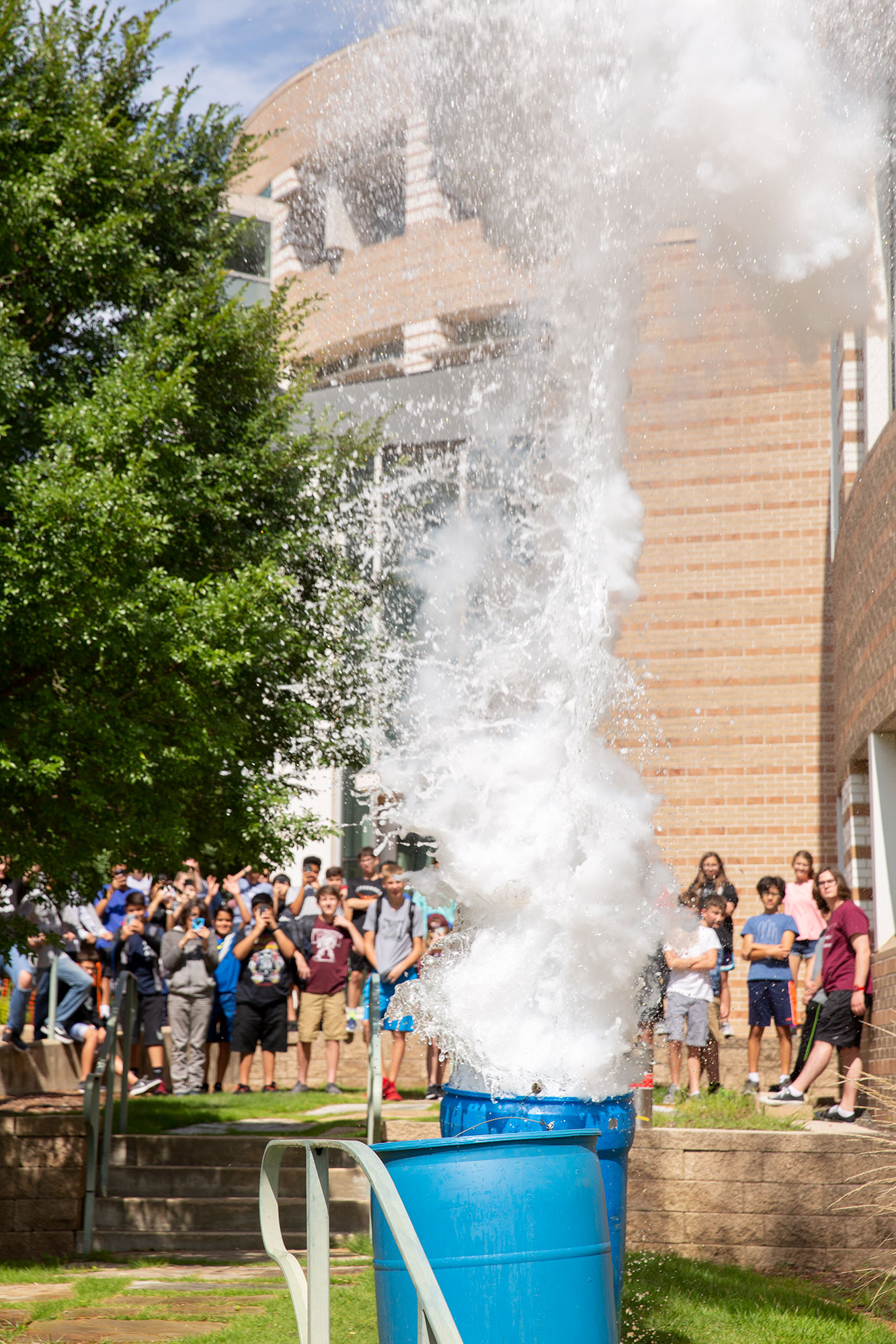 LN2 barrel depth charge blasting water into the air as children watch in amazement.